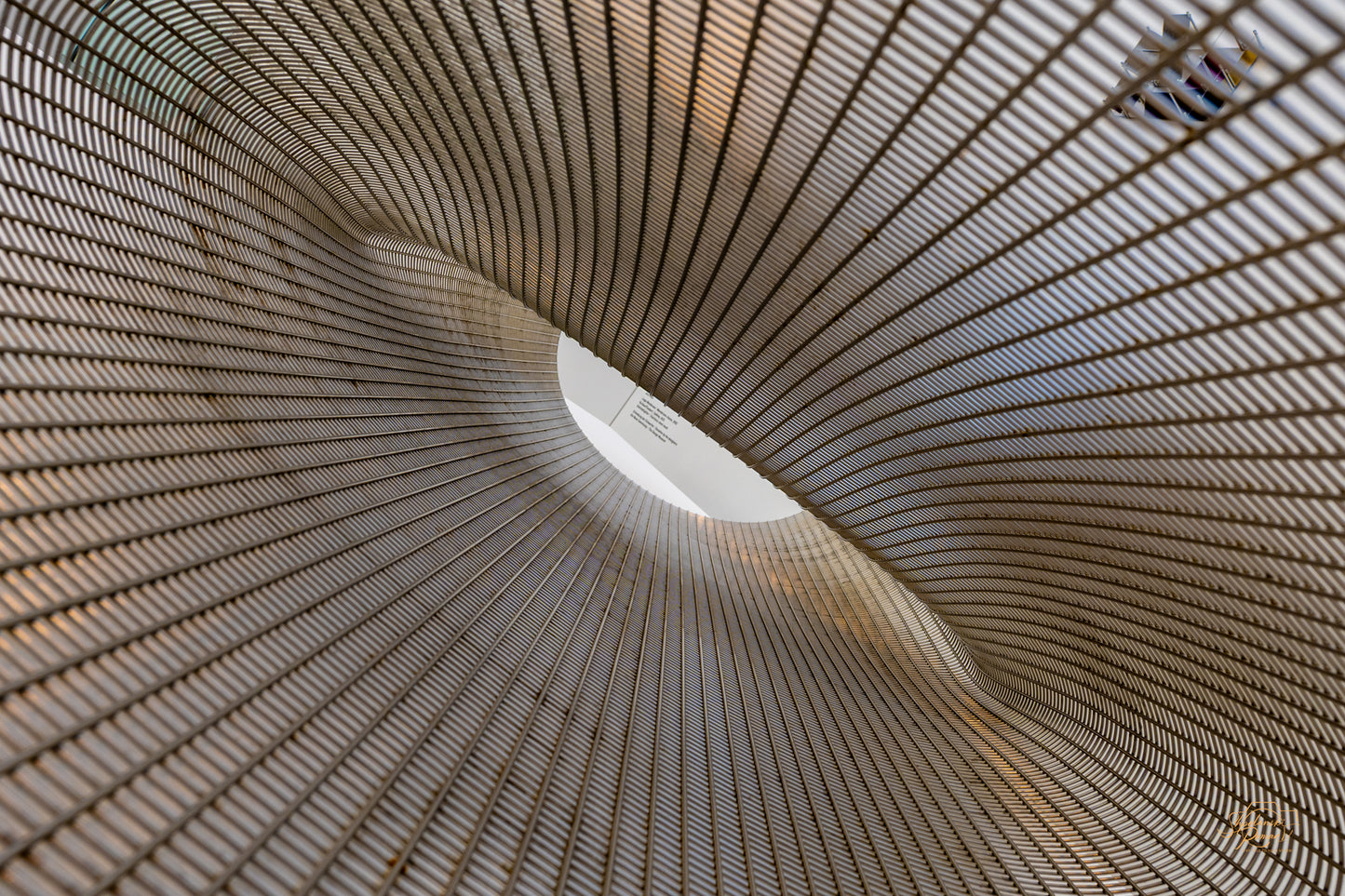 Spiral vortex view inside a woven metal mesh sculpture