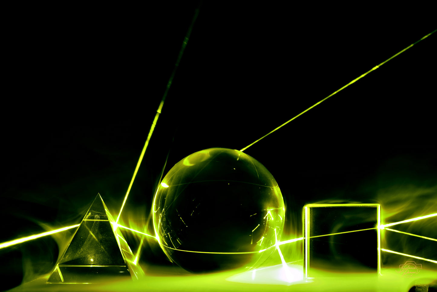 Warm green and gold laser lines in darkness