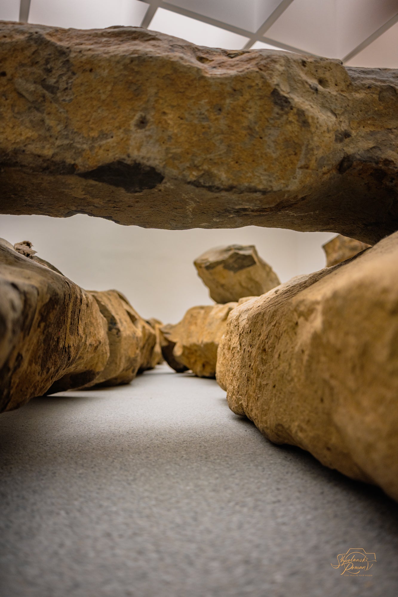 Large boulders framing a glowing horizon in a cave-like interior