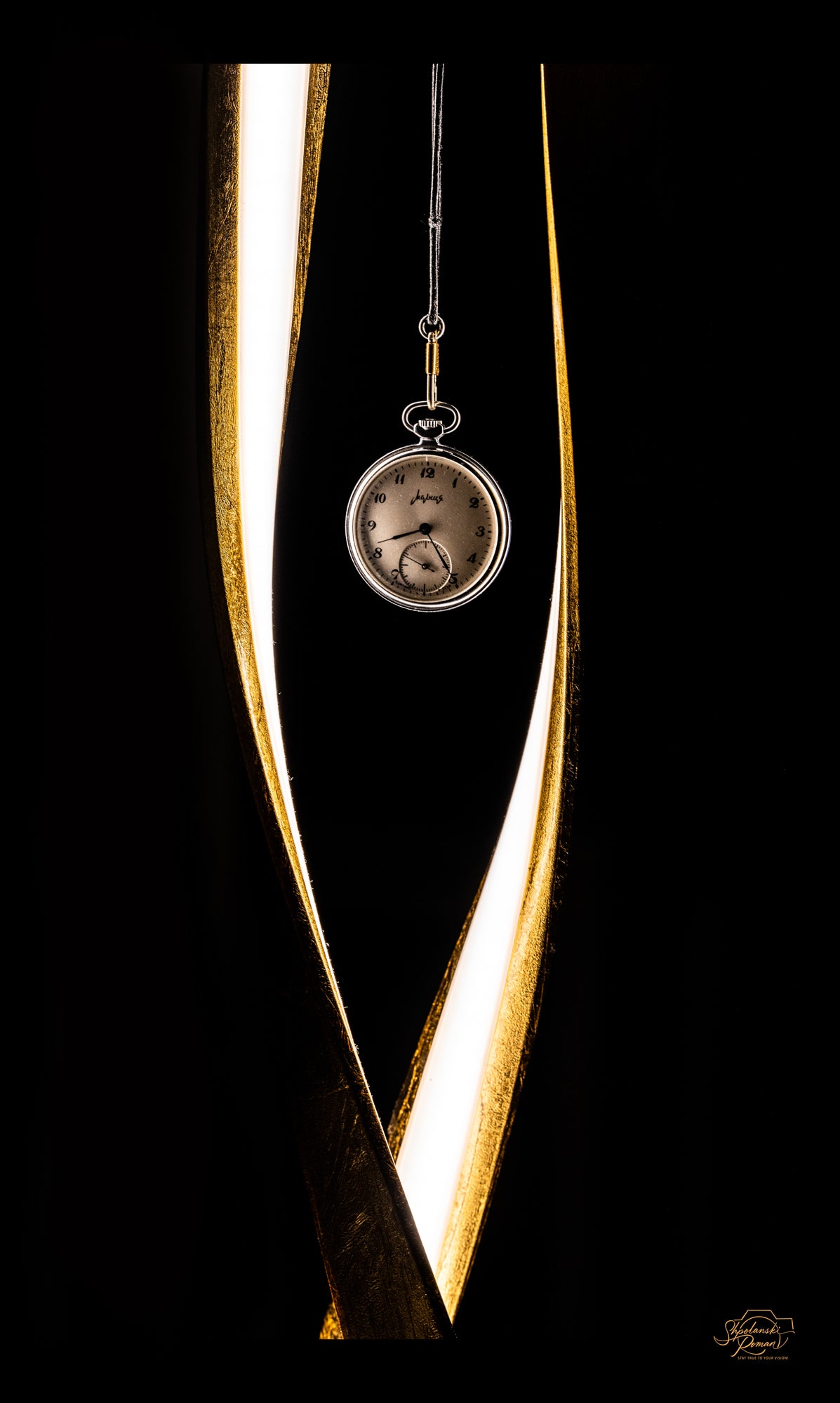 A pocket watch suspended within a golden sculpture