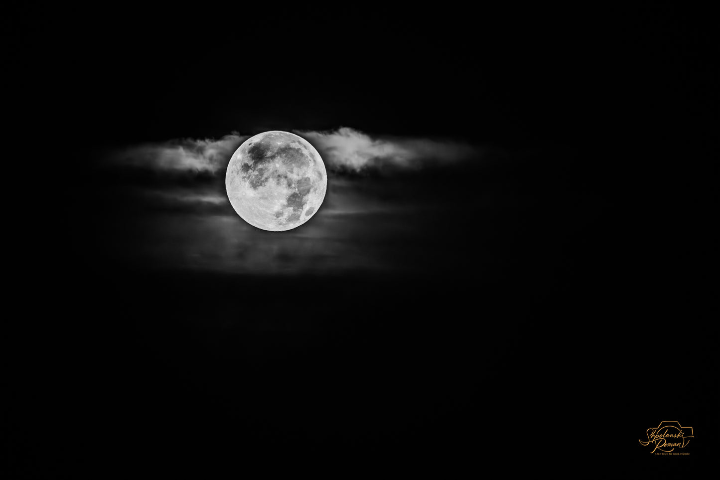Moon among clouds in black and white
