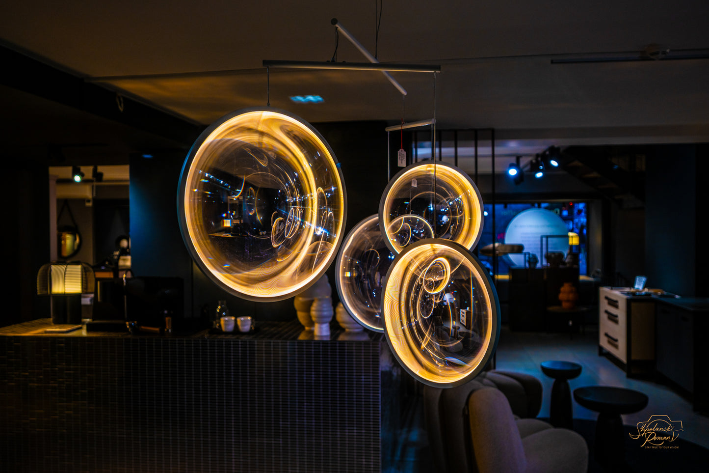 Golden spirals of light painted in a dark interior