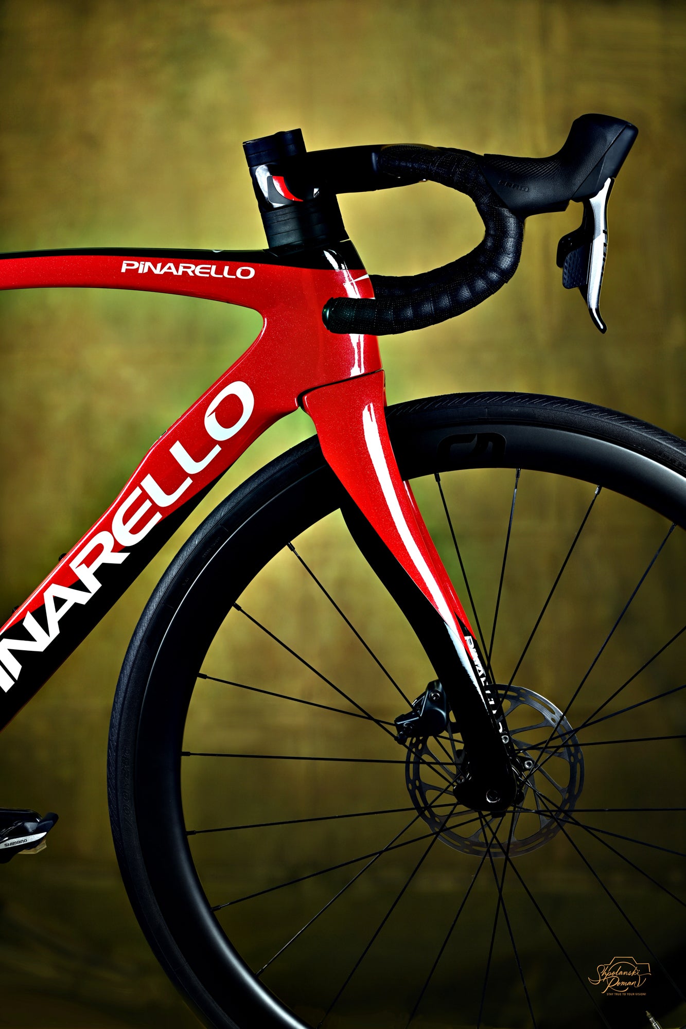 A red Pinarello racing bike in warm amber light