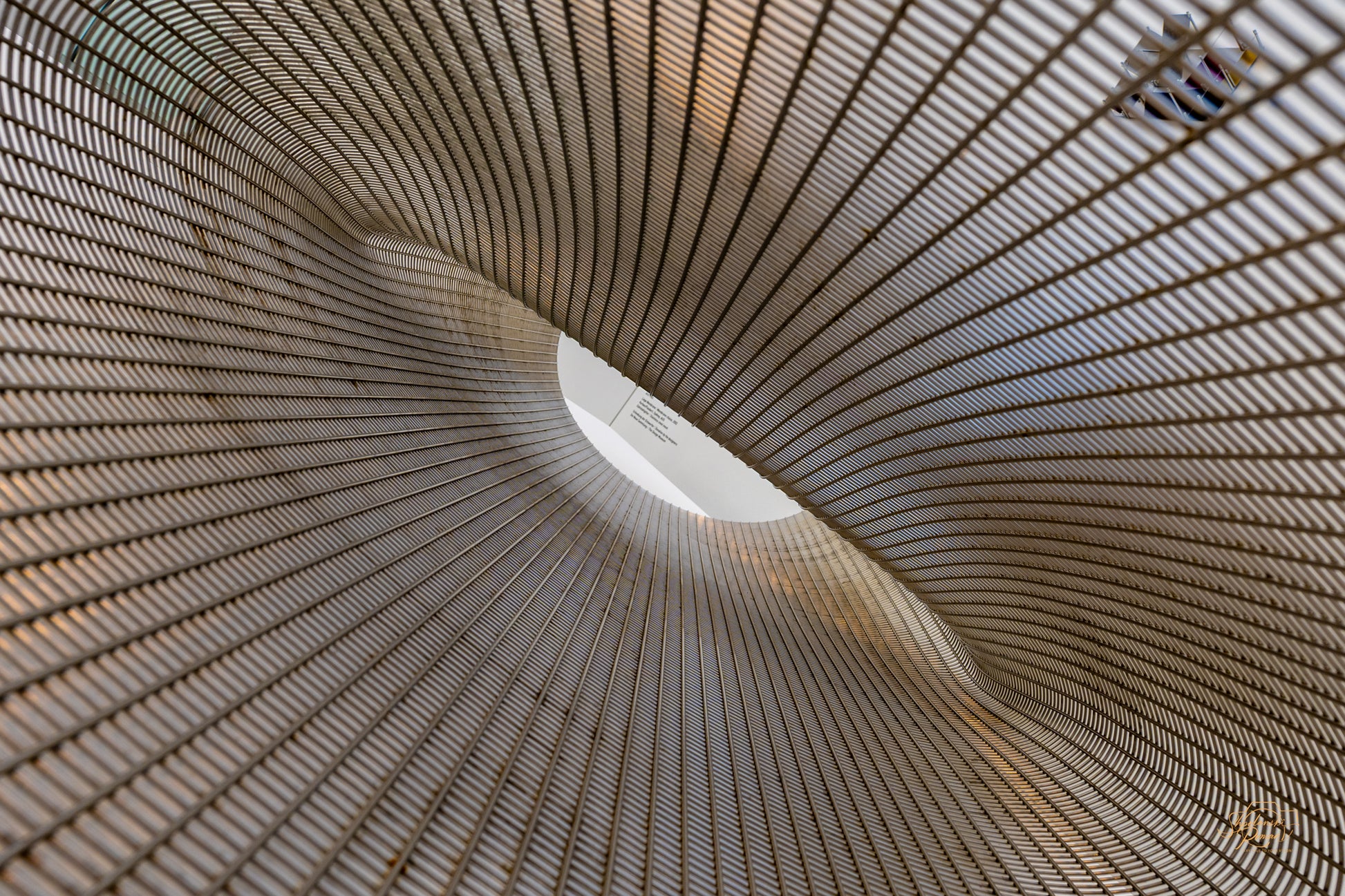 Spiral vortex view inside a woven metal mesh sculpture
