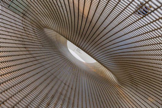 Spiral vortex view inside a woven metal mesh sculpture