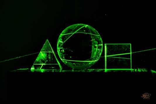 A glowing green laser arch and circle in darkness