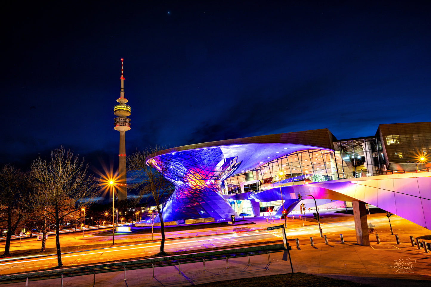 Munich Olympiapark at night with the tower, blue and violet light