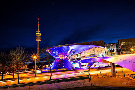 Munich Olympiapark at night with the tower, blue and violet light