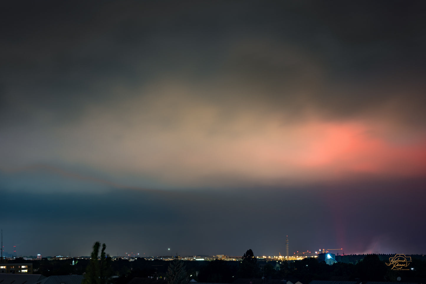 City skyline at dusk under a red sky