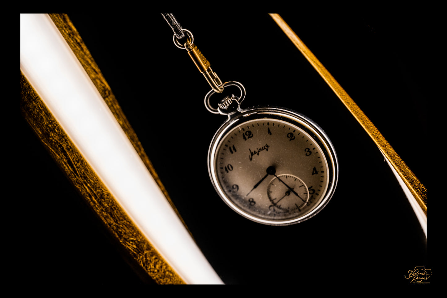 Golden curves cradling an old pocket watch
