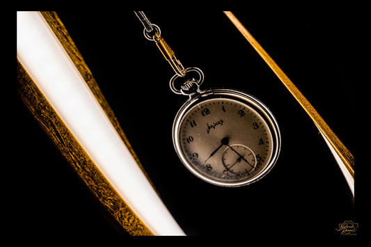 Golden curves cradling an old pocket watch