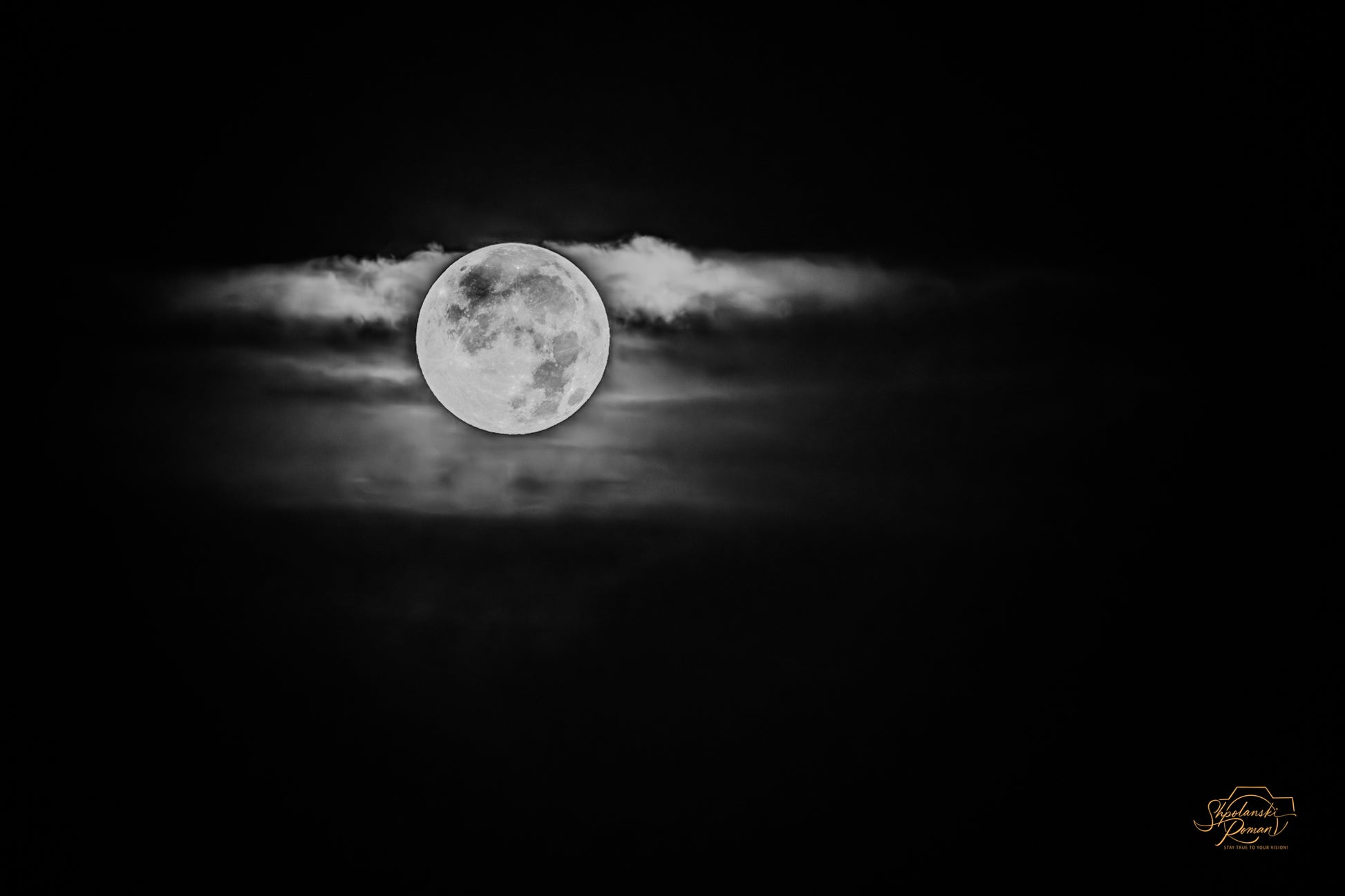 Moon among clouds in black and white, wider glow